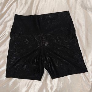 Black, shiny snakeskin biker shorts. Size M.